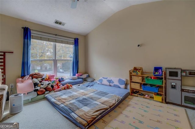 bedroom featuring ceiling fan, light carpet, and vaulted ceiling