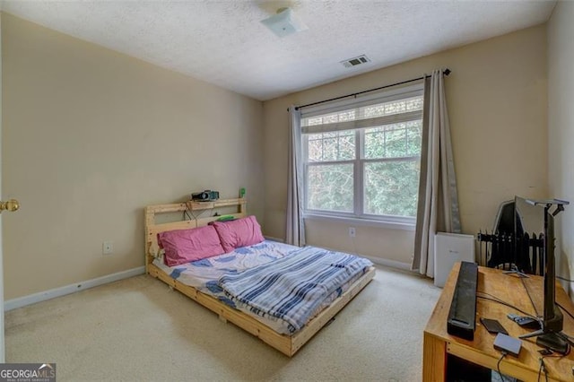 carpeted bedroom featuring a textured ceiling