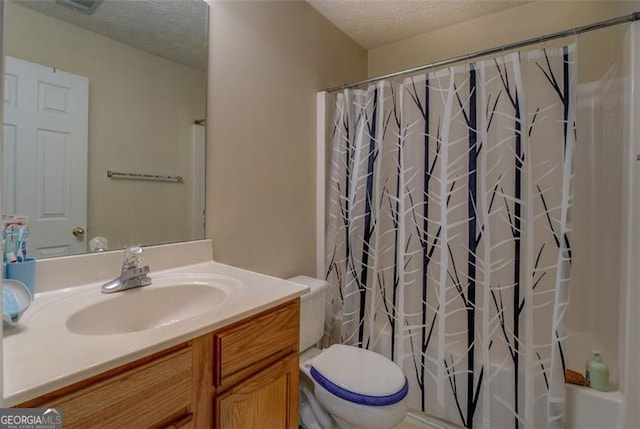 full bathroom featuring vanity, shower / tub combo, a textured ceiling, and toilet