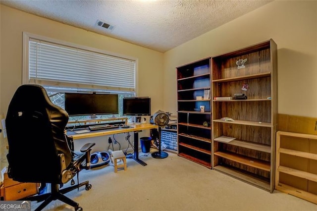 home office with carpet floors and a textured ceiling