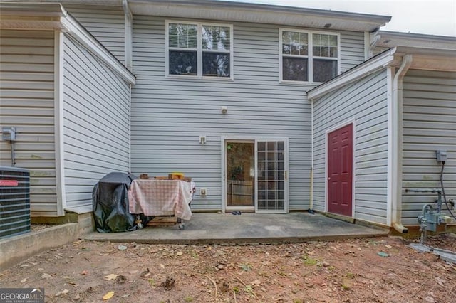 rear view of property featuring a patio area and central AC