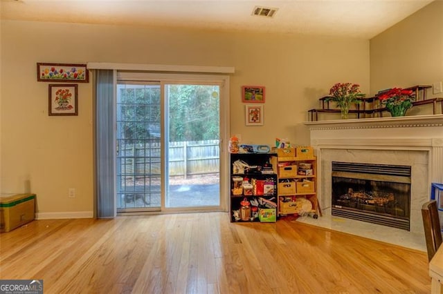 interior space with wood-type flooring and a high end fireplace