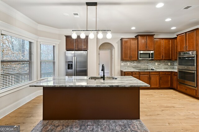 entrance foyer with crown molding, light hardwood / wood-style flooring, a towering ceiling, and a notable chandelier