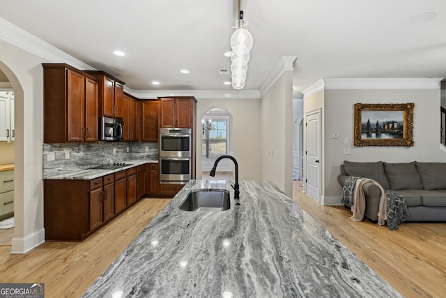 unfurnished dining area featuring light hardwood / wood-style floors, an inviting chandelier, crown molding, and coffered ceiling