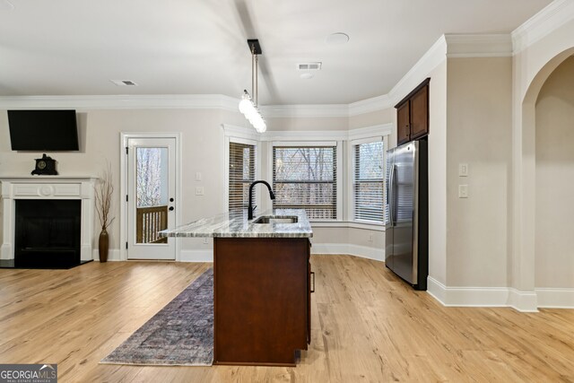 foyer with beam ceiling, ornamental molding, a towering ceiling, and light hardwood / wood-style flooring