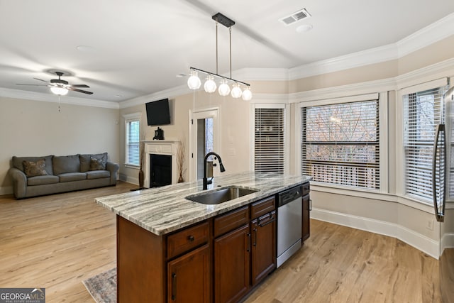 foyer entrance featuring an inviting chandelier, a towering ceiling, light hardwood / wood-style floors, and ornamental molding