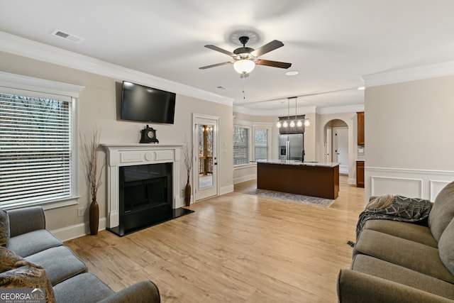 home office featuring crown molding and light hardwood / wood-style floors