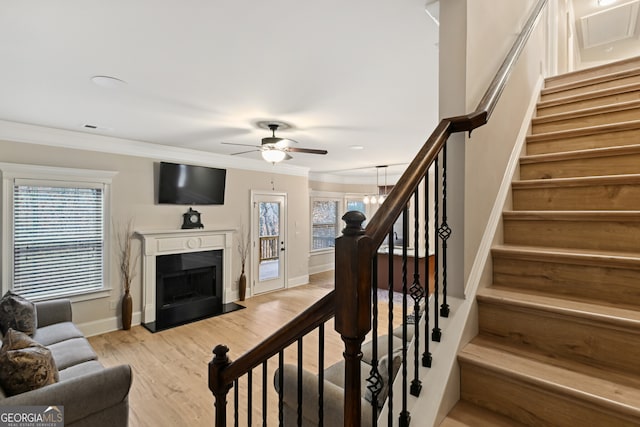 kitchen with a center island with sink, sink, light stone countertops, appliances with stainless steel finishes, and decorative light fixtures