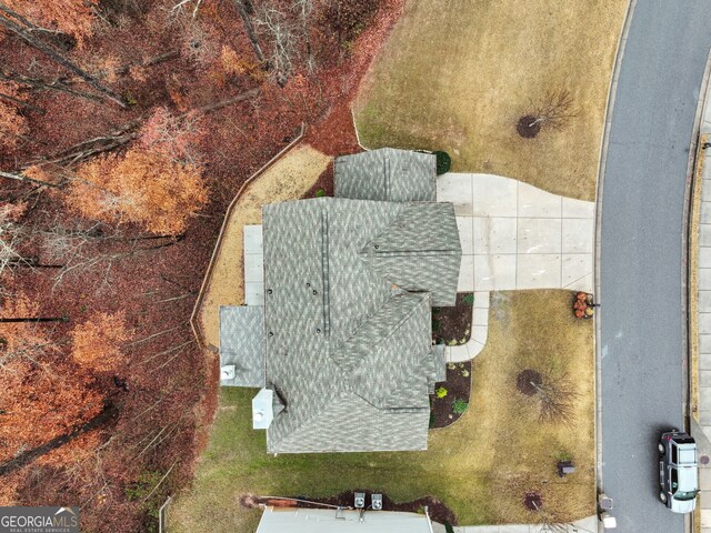 view of front facade featuring a front lawn, central AC unit, and a garage