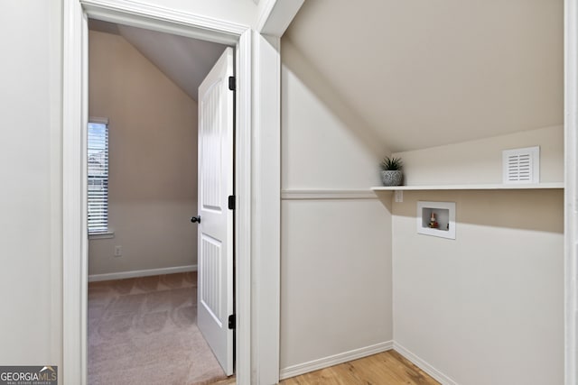 washroom with hookup for a washing machine and light hardwood / wood-style floors