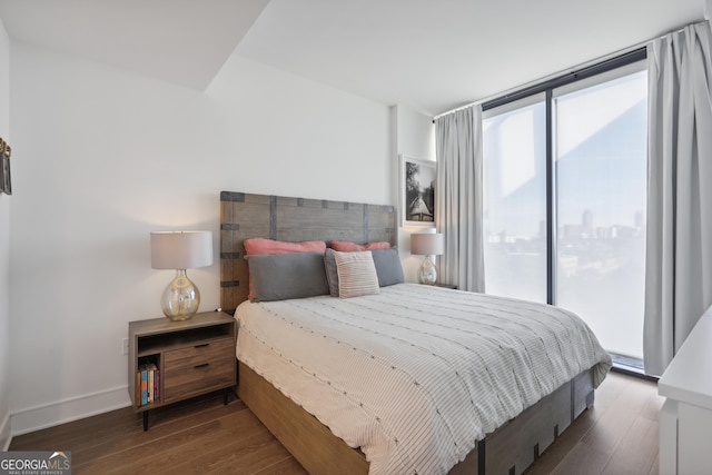 bedroom featuring access to exterior and dark wood-type flooring