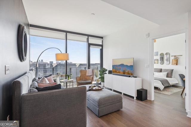 living room with floor to ceiling windows and dark wood-type flooring