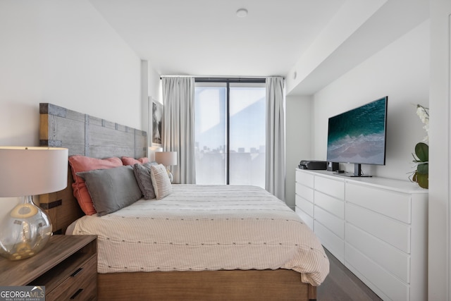 bedroom with dark hardwood / wood-style flooring