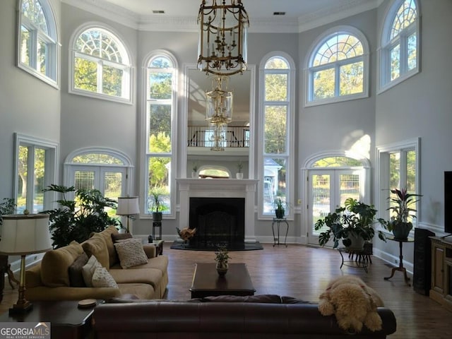 living room featuring french doors, hardwood / wood-style floors, and ornamental molding