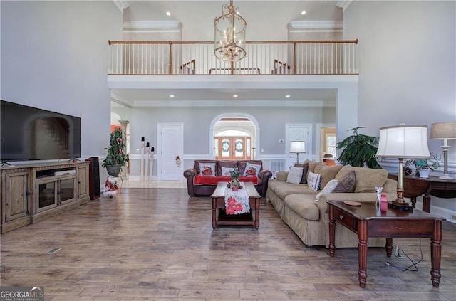 living room featuring hardwood / wood-style floors and crown molding