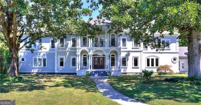 view of front of property with covered porch and a front yard