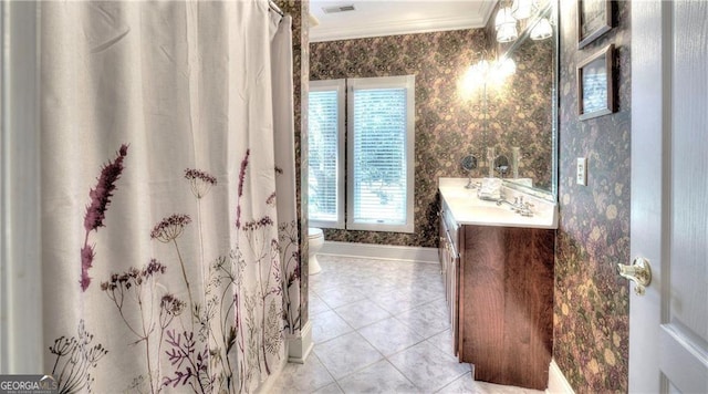 bathroom with plenty of natural light, toilet, crown molding, and vanity