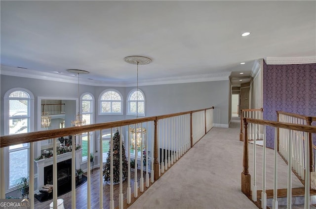 hall with light carpet and ornamental molding