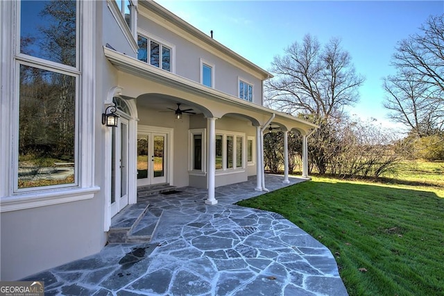 rear view of house with a lawn, ceiling fan, and a patio