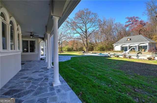 view of yard with ceiling fan