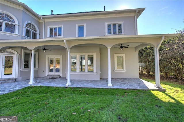 back of property with a lawn, ceiling fan, and a patio