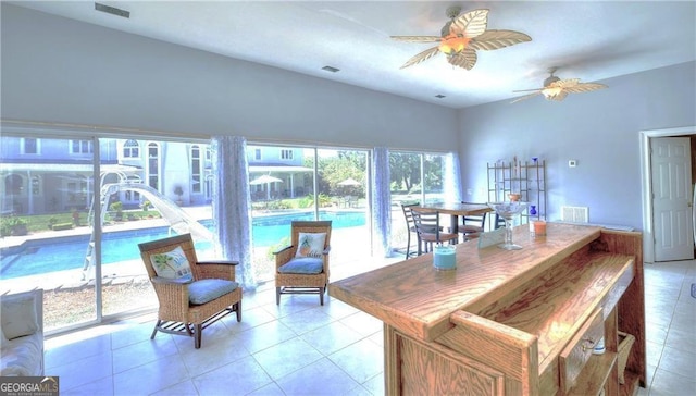 interior space with ceiling fan, a healthy amount of sunlight, and light tile patterned flooring