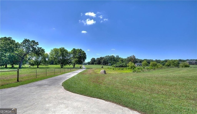 view of home's community with a yard and a rural view