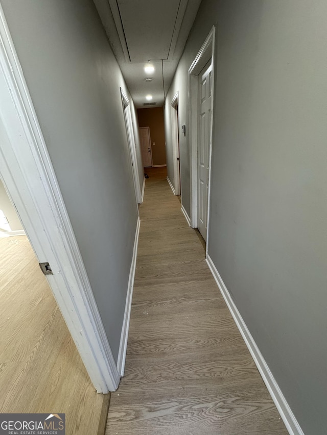 hall with light hardwood / wood-style flooring