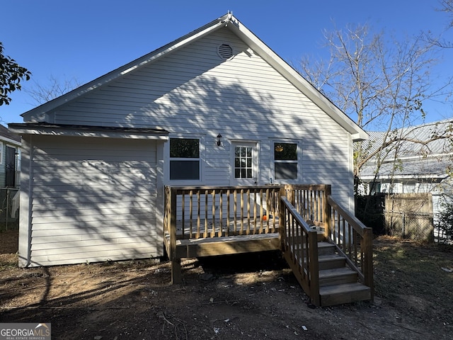 rear view of house featuring a deck