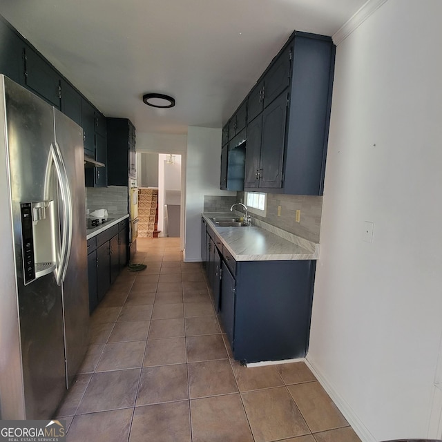 kitchen with light tile patterned floors, sink, stainless steel refrigerator with ice dispenser, tasteful backsplash, and black electric cooktop