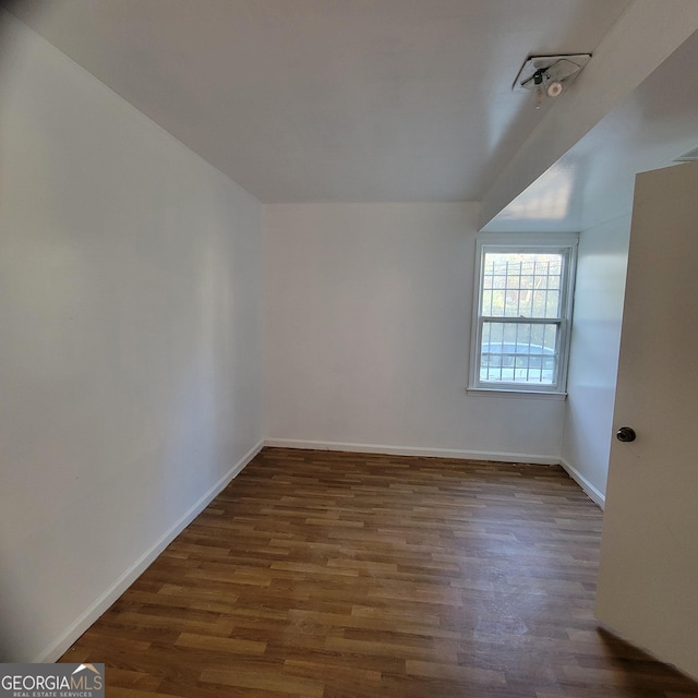 unfurnished room featuring dark hardwood / wood-style floors