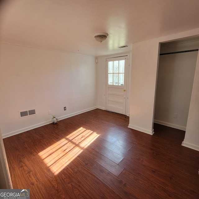 unfurnished bedroom featuring dark hardwood / wood-style floors