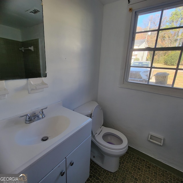 bathroom featuring vanity, toilet, and a wealth of natural light