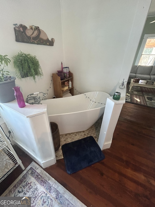 bathroom featuring hardwood / wood-style flooring and a washtub