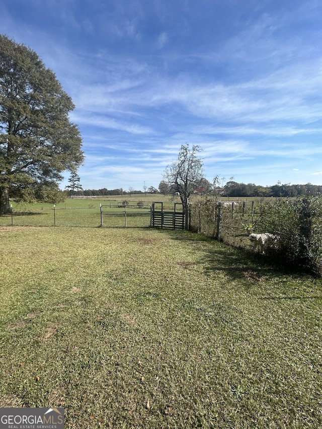 view of yard with a rural view