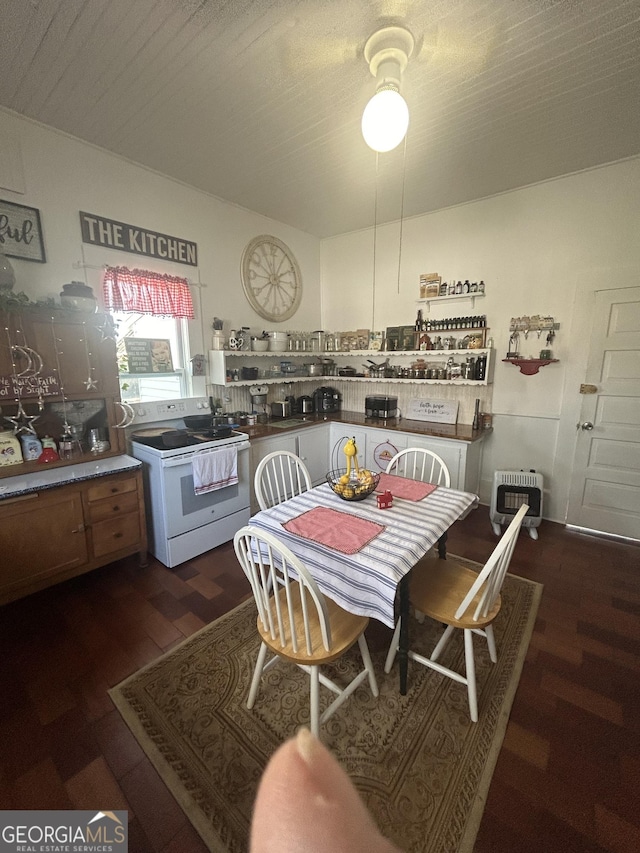 kitchen with electric range, heating unit, and dark wood-type flooring