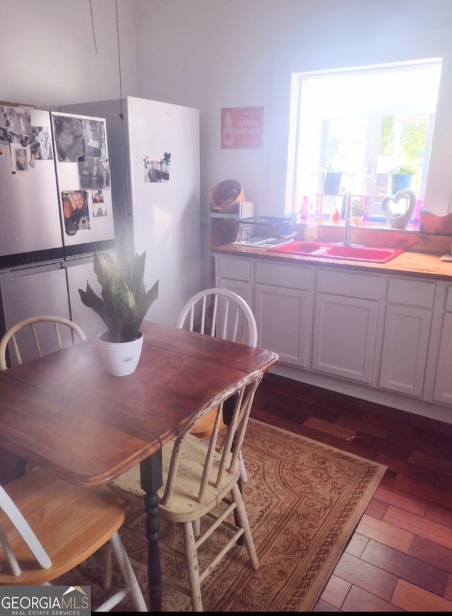 dining room featuring dark wood-type flooring and sink