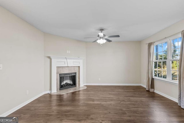 unfurnished living room with ceiling fan and dark wood-type flooring