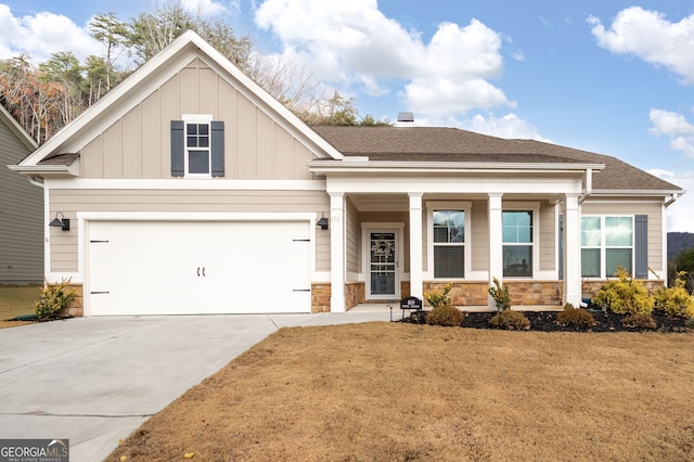 craftsman inspired home with a front yard and a garage