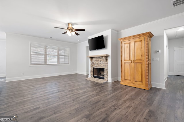 unfurnished living room featuring ceiling fan, a fireplace, dark hardwood / wood-style floors, and ornamental molding