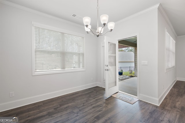 foyer entrance featuring dark hardwood / wood-style flooring, an inviting chandelier, and ornamental molding