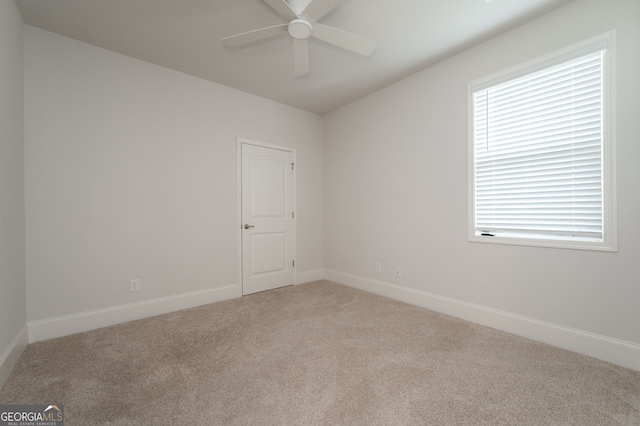 carpeted spare room with ceiling fan and a wealth of natural light