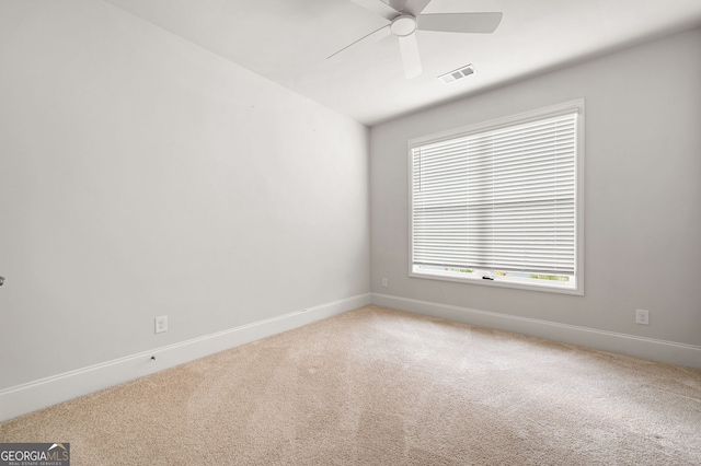 unfurnished room featuring ceiling fan and carpet