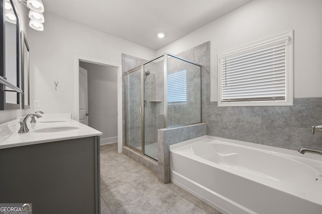 bathroom featuring vanity and shower with separate bathtub