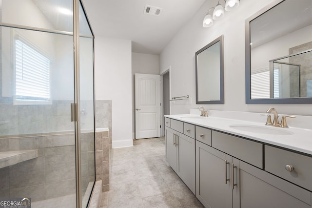 bathroom with vanity and a shower with shower door