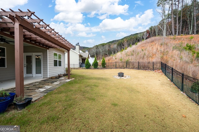 view of yard with a mountain view, a patio, and an outdoor fire pit