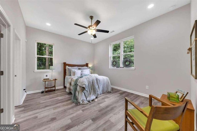 bedroom with ceiling fan and light hardwood / wood-style flooring