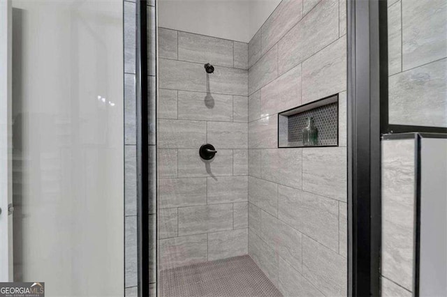 bathroom with a tile shower