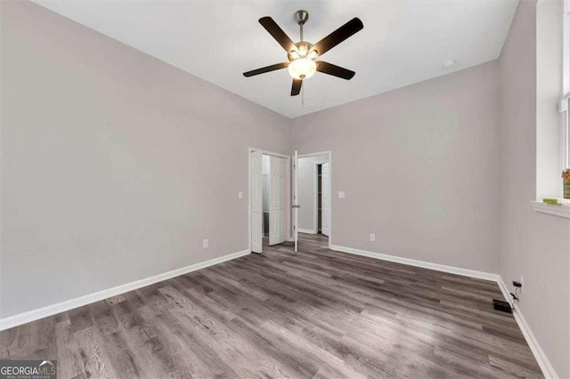 unfurnished bedroom featuring dark hardwood / wood-style flooring and ceiling fan