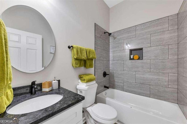 full bathroom with vanity, toilet, and tiled shower / bath combo